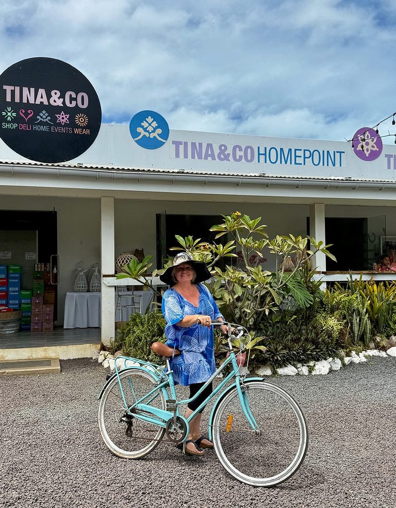 Megan on bike outside shop