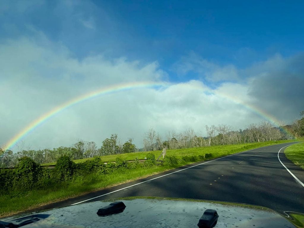 Rainbow across the rural road up Mt Haleakala