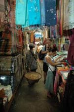 Walking along the stalls filled with fabric items.