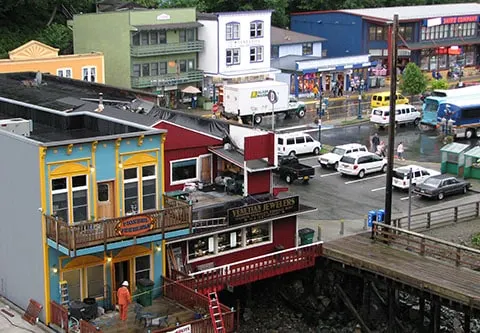 Colorful small buildings and a parking lot can be seen from my ship's cabin, showcasing one of Alaska's hidden gems and its capital city, Juneau.